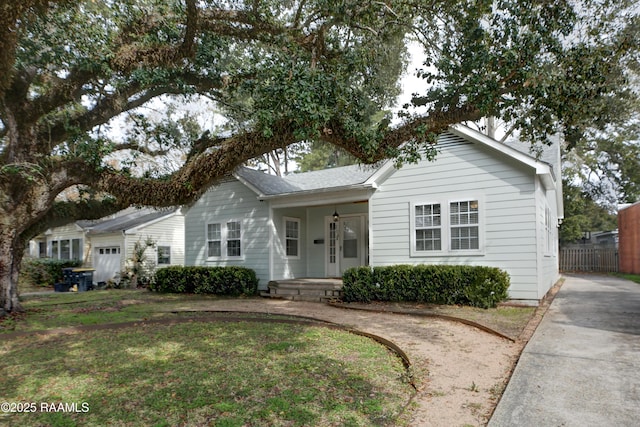 single story home with a garage and a front lawn