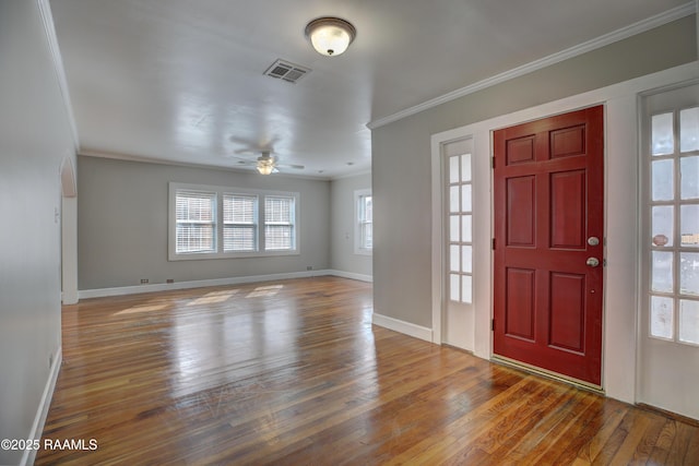 foyer with hardwood / wood-style floors, crown molding, and ceiling fan