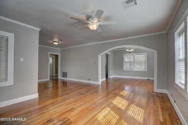 unfurnished room featuring wood-type flooring, ornamental molding, and ceiling fan with notable chandelier