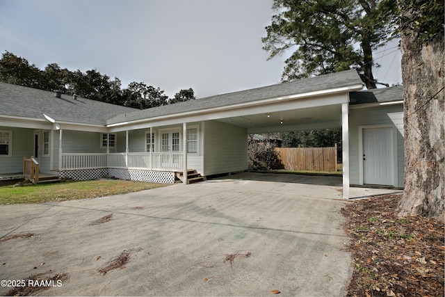 view of property exterior with a carport and covered porch