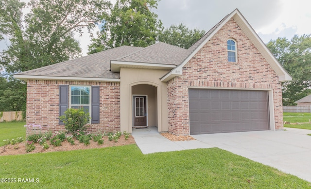 view of front facade with a garage and a front lawn