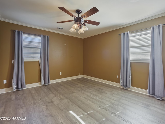 spare room with a healthy amount of sunlight, light hardwood / wood-style flooring, and ornamental molding