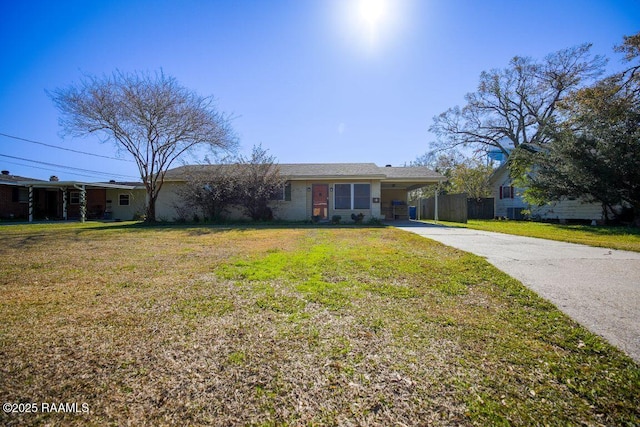 single story home with a front lawn and a carport