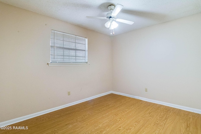 spare room featuring ceiling fan, a textured ceiling, and light wood-type flooring