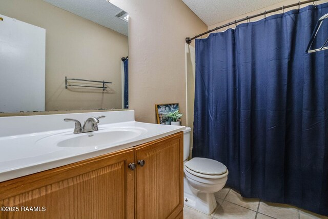 bathroom featuring vanity, walk in shower, toilet, tile patterned floors, and a textured ceiling