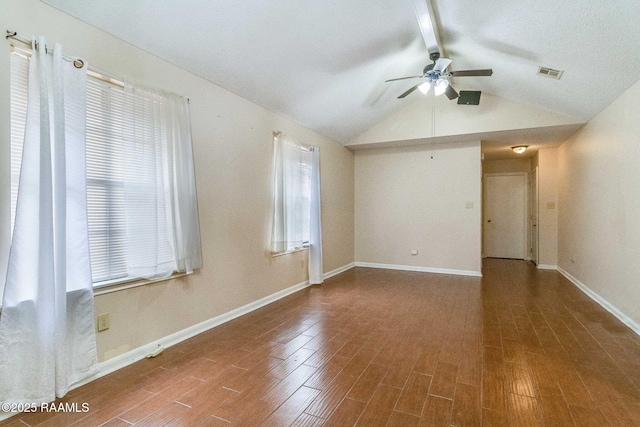 empty room with wood-type flooring, vaulted ceiling with beams, and ceiling fan