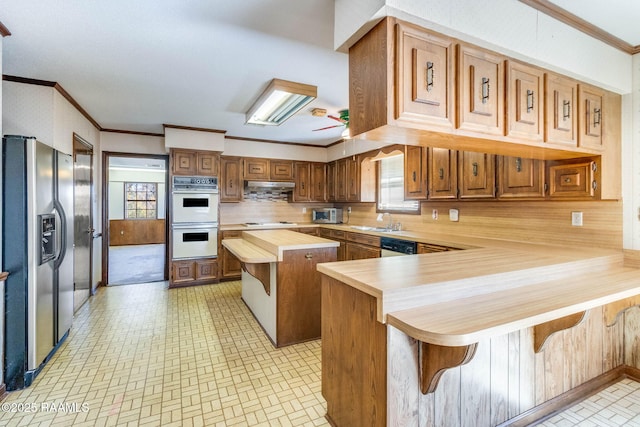 kitchen with a sink, white appliances, wooden counters, and ornamental molding