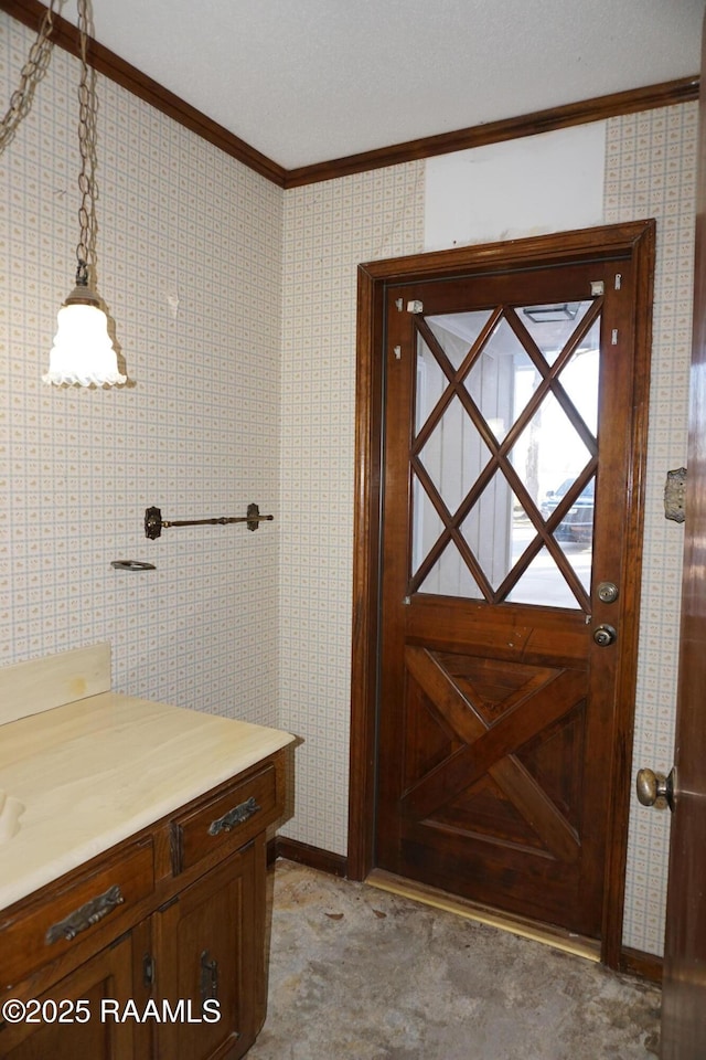 bathroom with wallpapered walls and crown molding