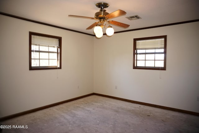 empty room featuring visible vents, baseboards, a wealth of natural light, and ornamental molding