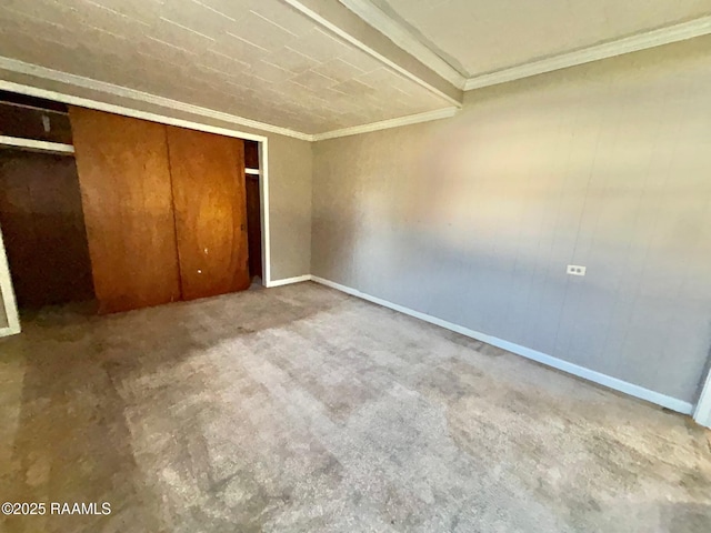 unfurnished bedroom featuring light carpet, crown molding, and a closet