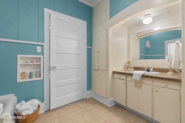 bathroom with vanity and ornamental molding