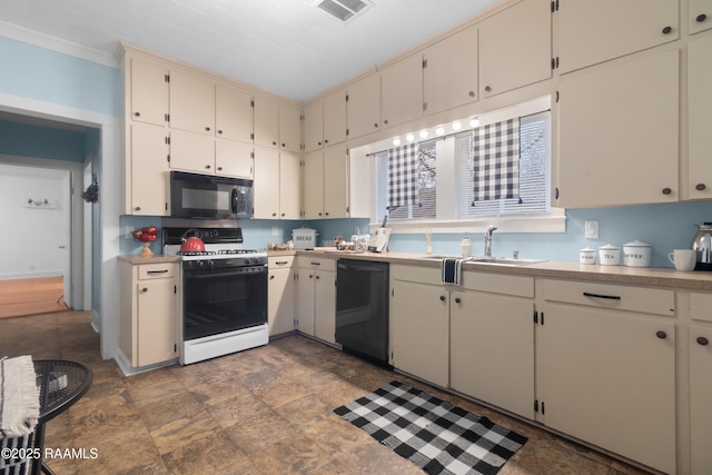 kitchen with cream cabinets, sink, and black appliances