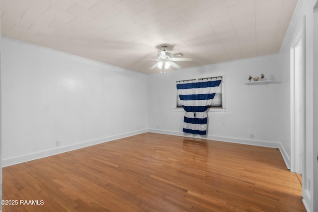 unfurnished room with ceiling fan, wood-type flooring, and ornamental molding