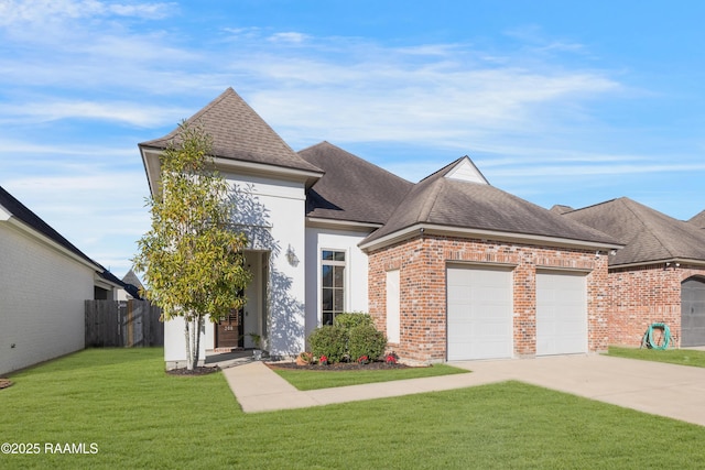 view of front facade with a front yard and a garage