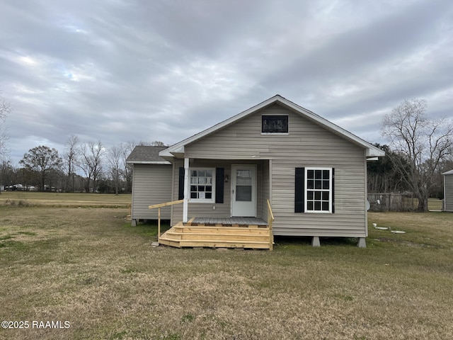 back of house with a yard and a deck