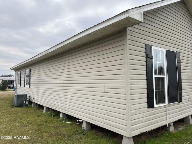 view of property exterior featuring a yard and central AC