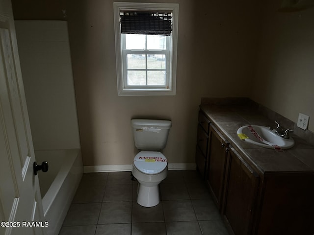 bathroom with vanity, a washtub, tile patterned flooring, and toilet