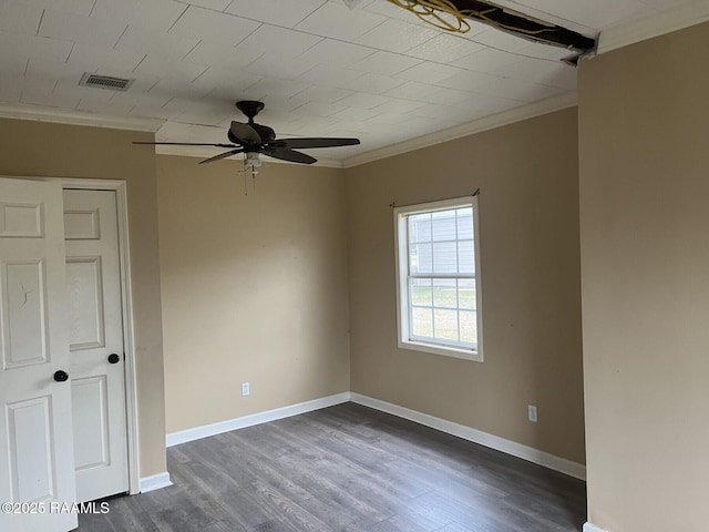 empty room with crown molding, dark wood-type flooring, and ceiling fan