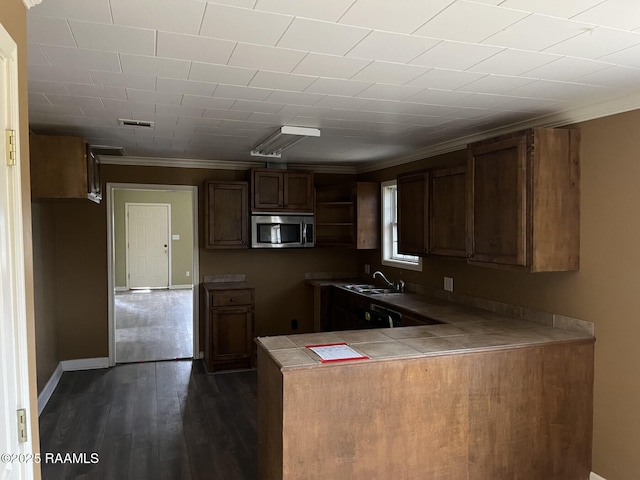 kitchen with dark wood-type flooring, sink, crown molding, tile counters, and kitchen peninsula