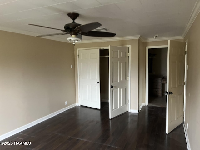 unfurnished bedroom with dark hardwood / wood-style flooring, crown molding, a closet, and ceiling fan