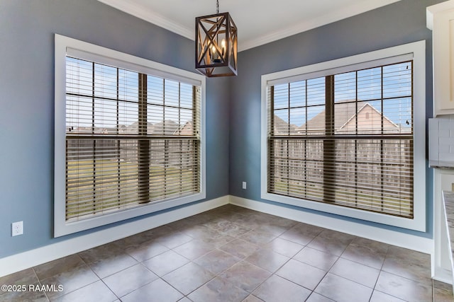 empty room with ornamental molding, a chandelier, and dark tile patterned floors