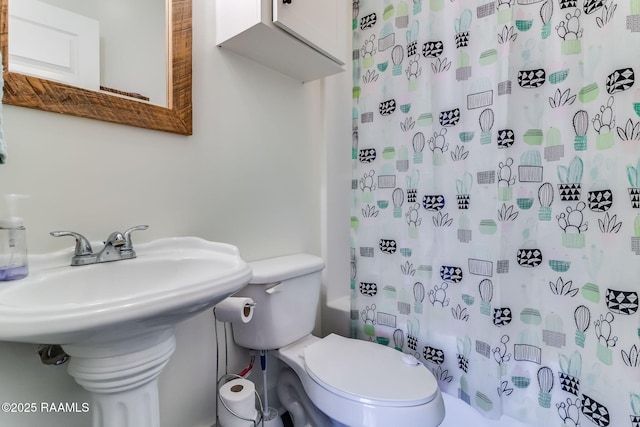 bathroom with shower / bathtub combination with curtain and toilet