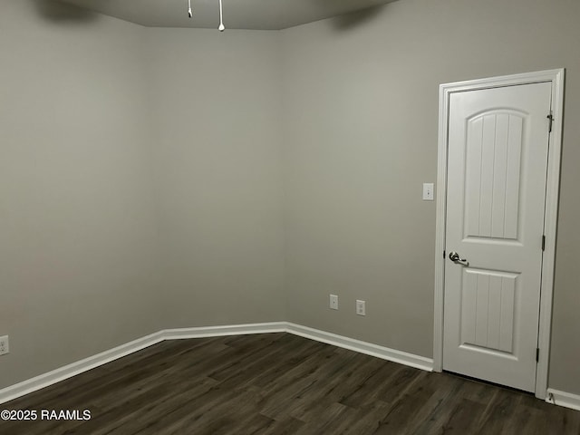 unfurnished room featuring dark hardwood / wood-style flooring