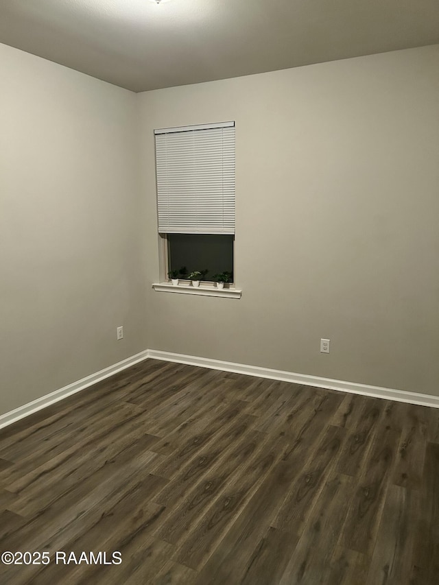 spare room featuring dark wood-type flooring