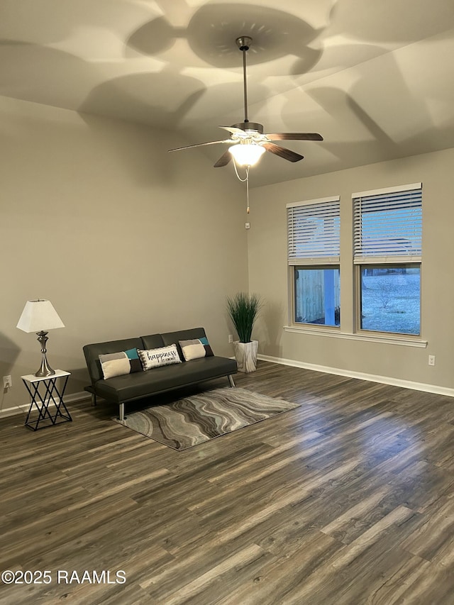 unfurnished living room with dark wood-type flooring and ceiling fan