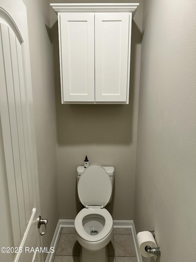 bathroom featuring tile patterned floors and toilet