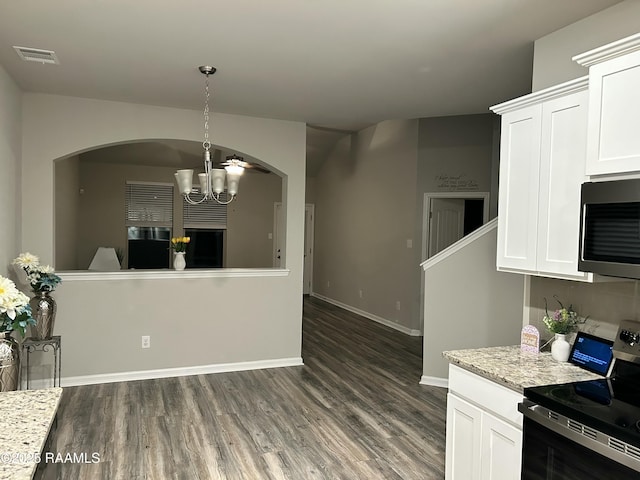 kitchen featuring pendant lighting, white cabinets, a chandelier, and electric range