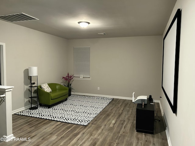 sitting room featuring dark wood-type flooring