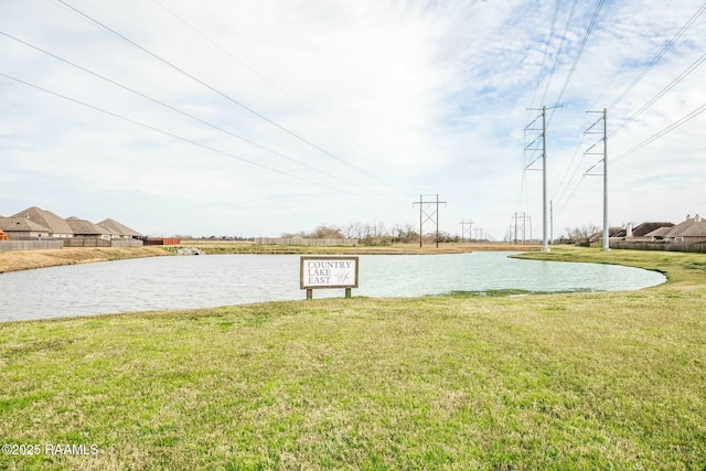 exterior space with a water view and a lawn