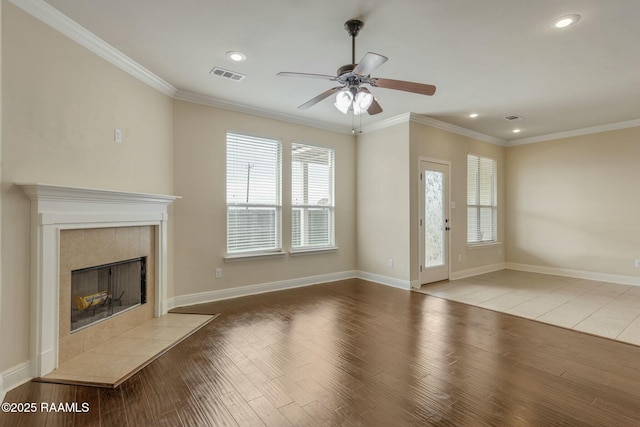 unfurnished living room with ceiling fan, ornamental molding, a fireplace, and light hardwood / wood-style floors