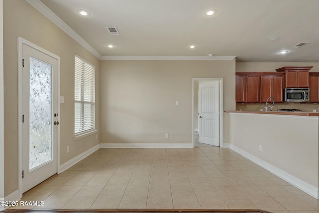 kitchen with backsplash, crown molding, sink, and light tile patterned flooring