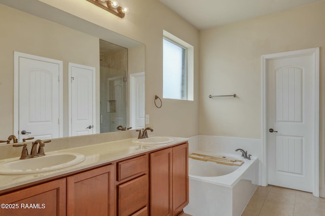 bathroom featuring vanity, tile patterned flooring, and shower with separate bathtub