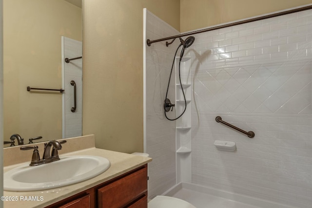 bathroom featuring vanity, toilet, and walk in shower