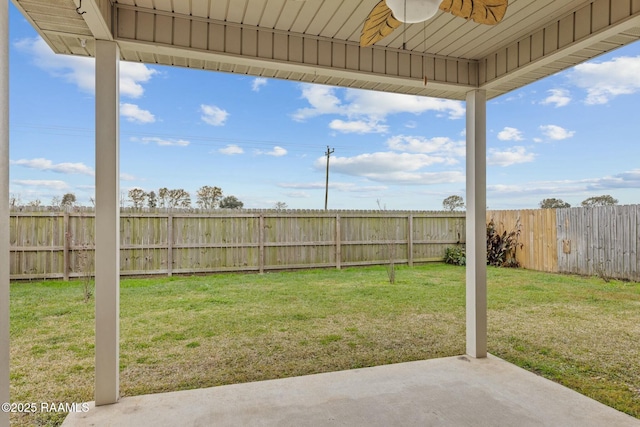 view of yard with ceiling fan and a patio area