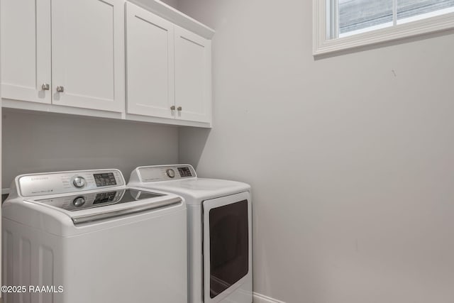 laundry area featuring cabinets and washing machine and clothes dryer