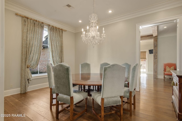 dining area featuring light hardwood / wood-style floors, a wealth of natural light, and ornamental molding