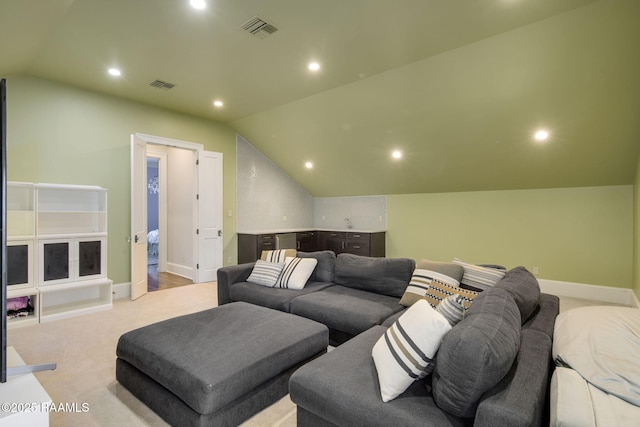 carpeted home theater room featuring lofted ceiling