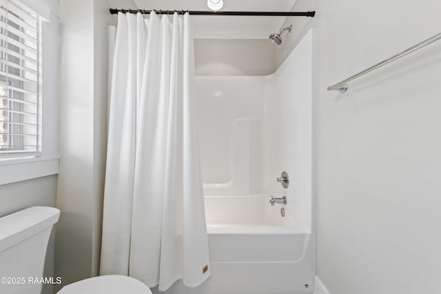 bathroom featuring toilet and shower / bath combo with shower curtain