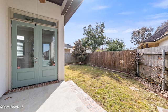 view of yard featuring french doors, ceiling fan, and a patio area