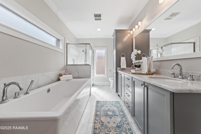 bathroom featuring vanity, tiled tub, crown molding, and toilet