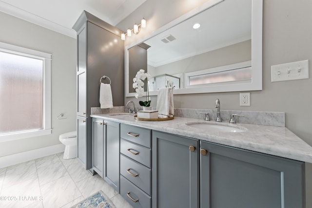 bathroom with crown molding, vanity, and toilet