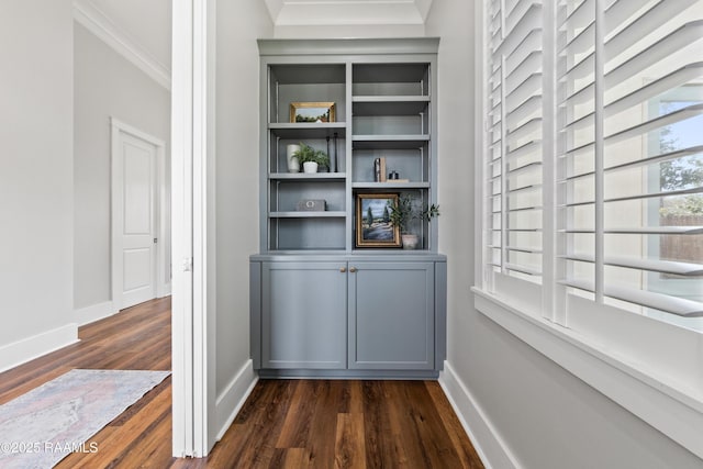 interior details with ornamental molding and hardwood / wood-style floors