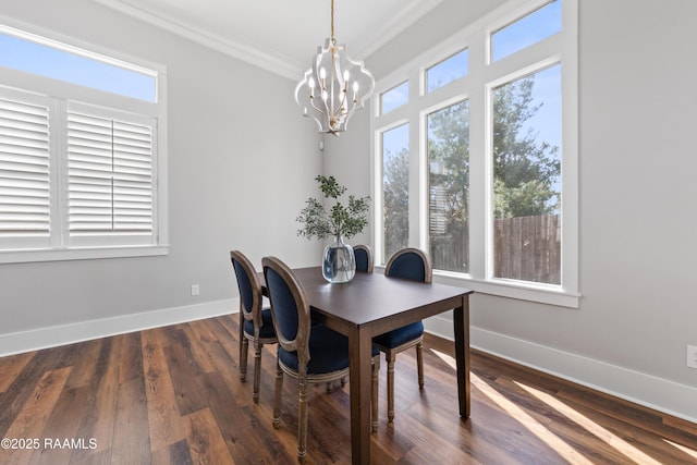 dining area with an inviting chandelier, ornamental molding, and dark hardwood / wood-style flooring