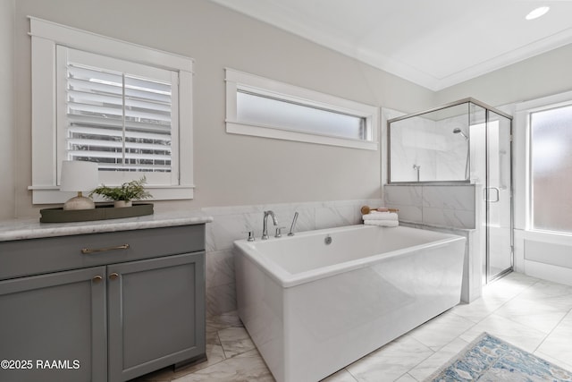 bathroom with vanity, crown molding, plenty of natural light, and shower with separate bathtub