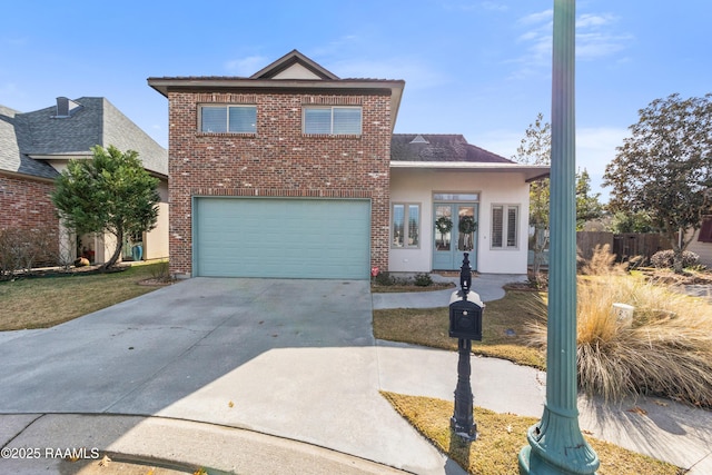 view of property featuring a garage and french doors