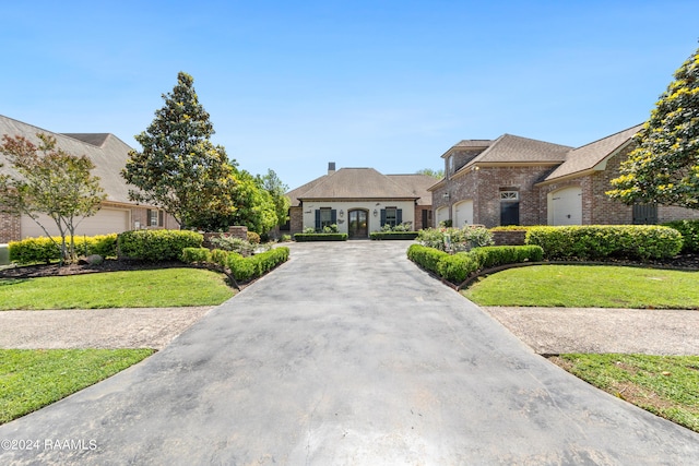 french country style house with a front yard